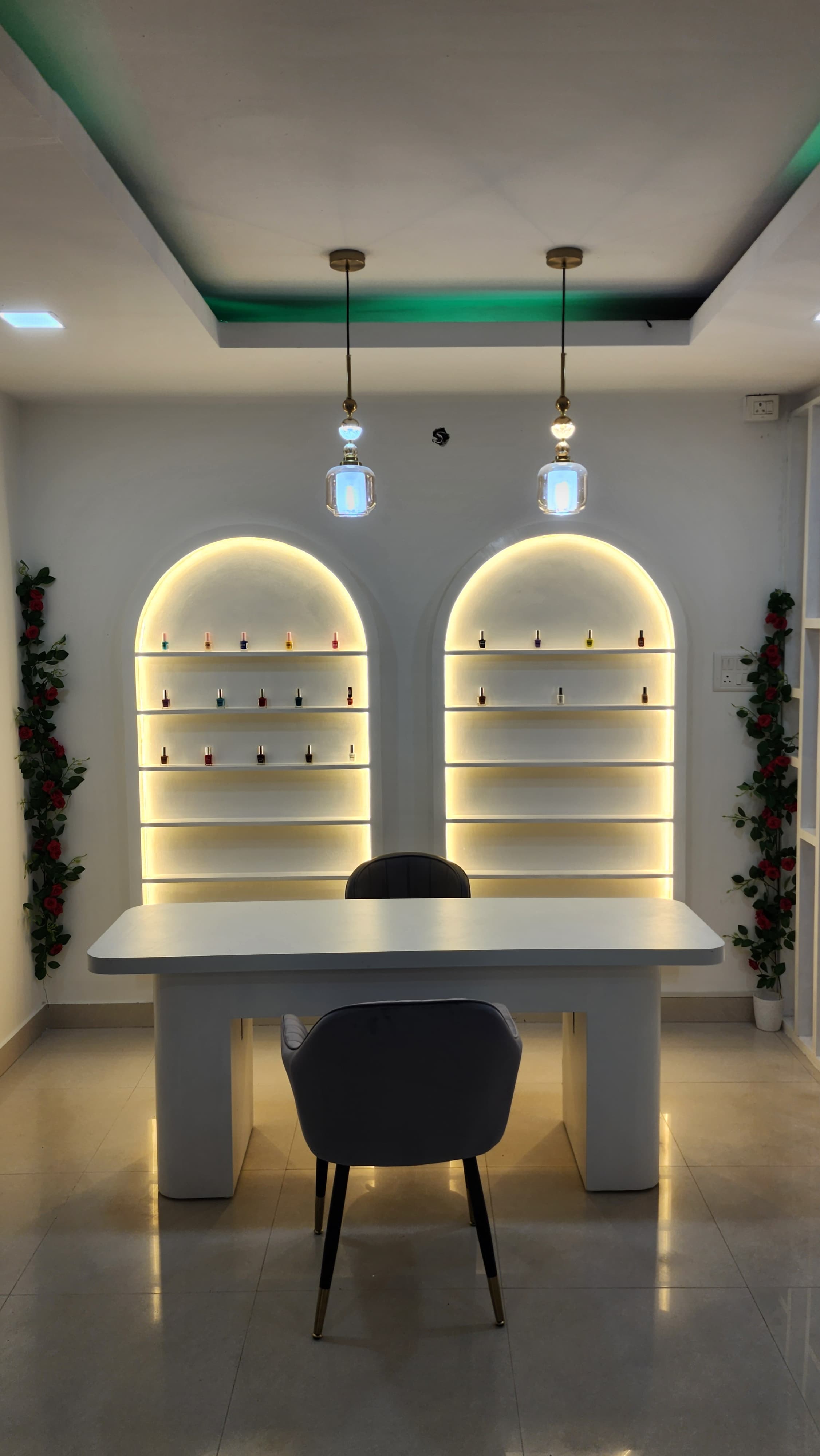 Nail art station with backlit arch shelves displaying nail polishes